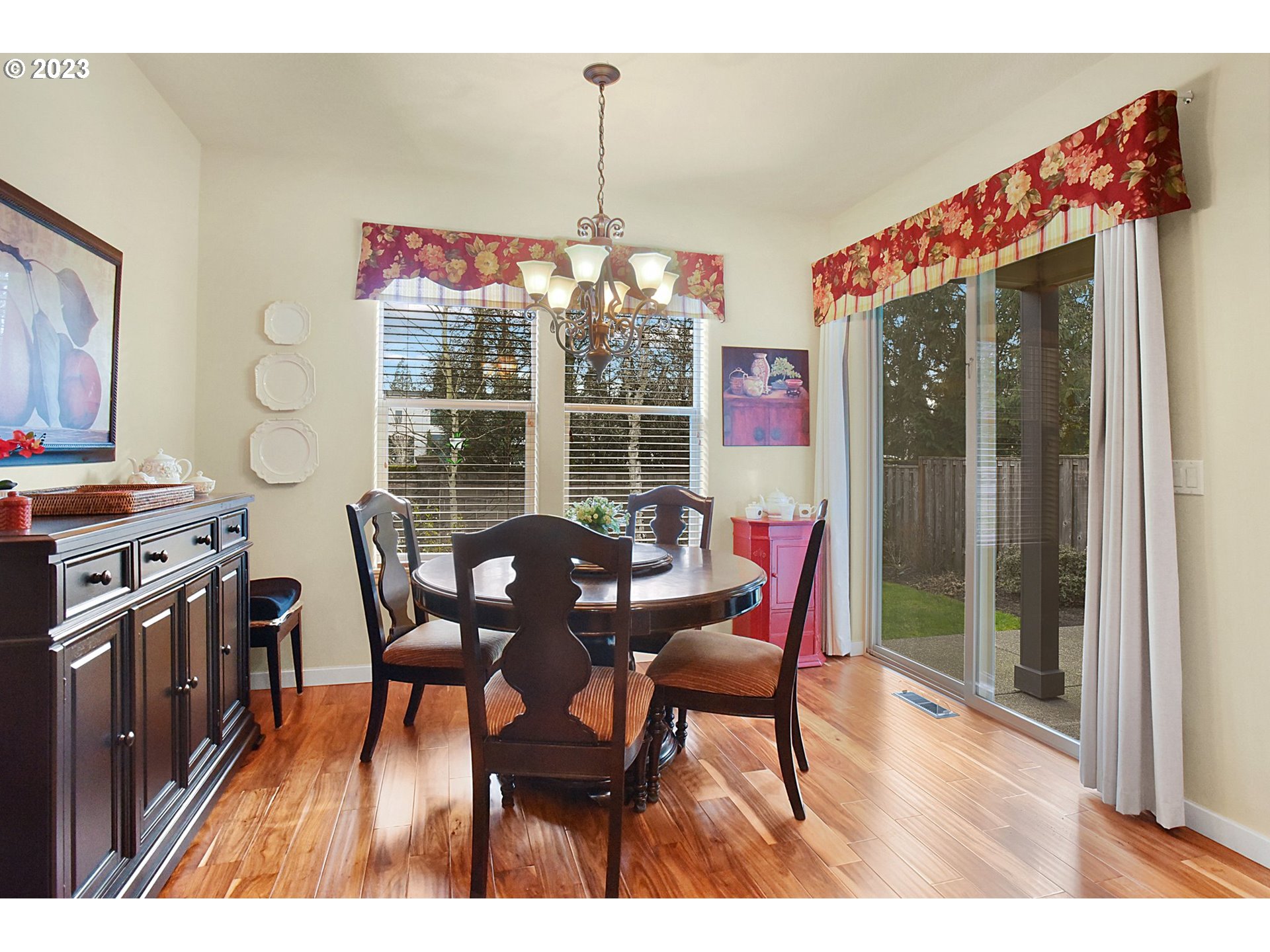 7826 Southwest Alder Street Tigard, OR 97224 - Photo 13 of 30 a dining room with furniture a chandelier and wooden floor