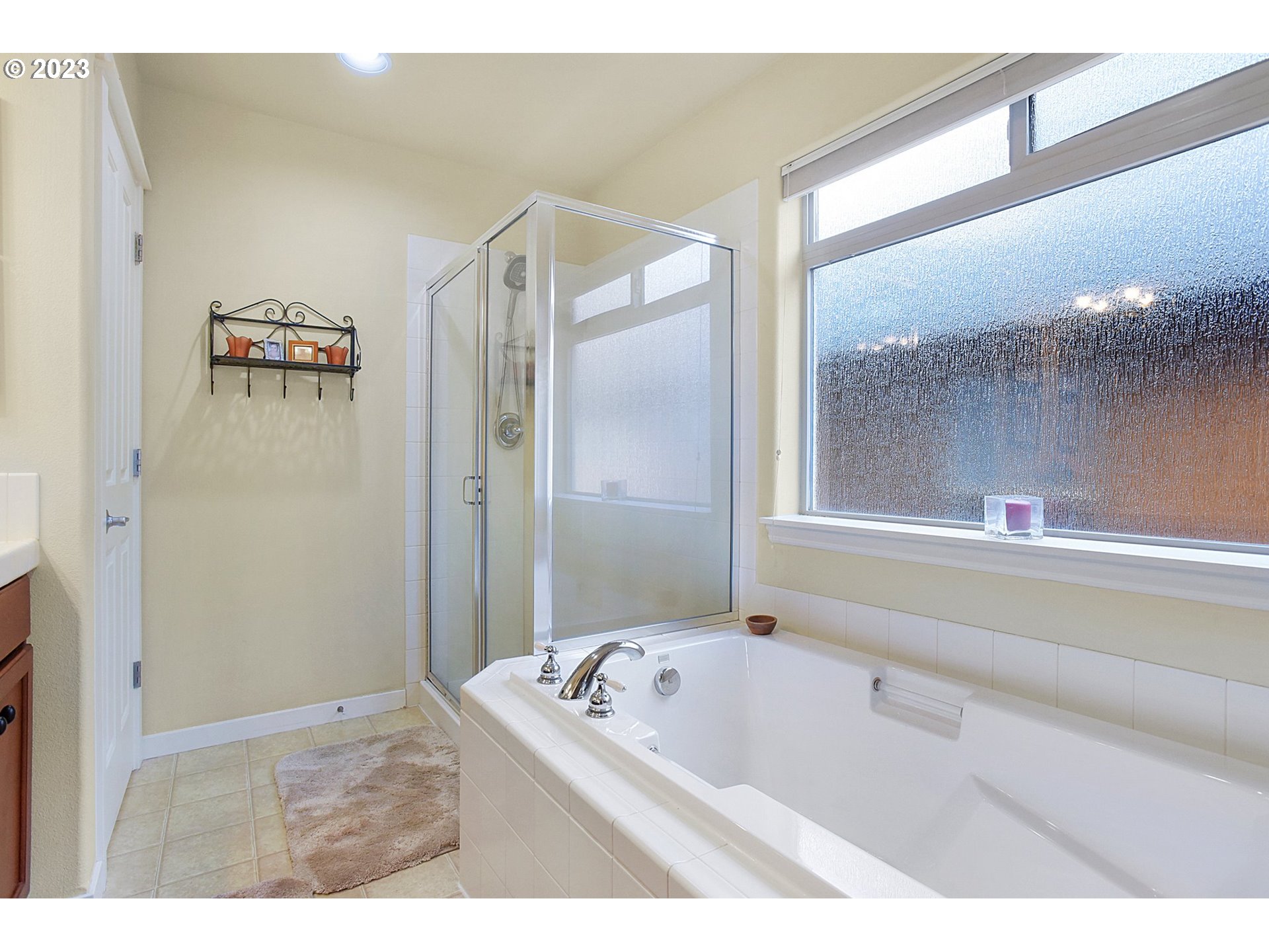 7826 Southwest Alder Street Tigard, OR 97224 - Photo 20 of 30 a bathroom with a bathtub and a shower