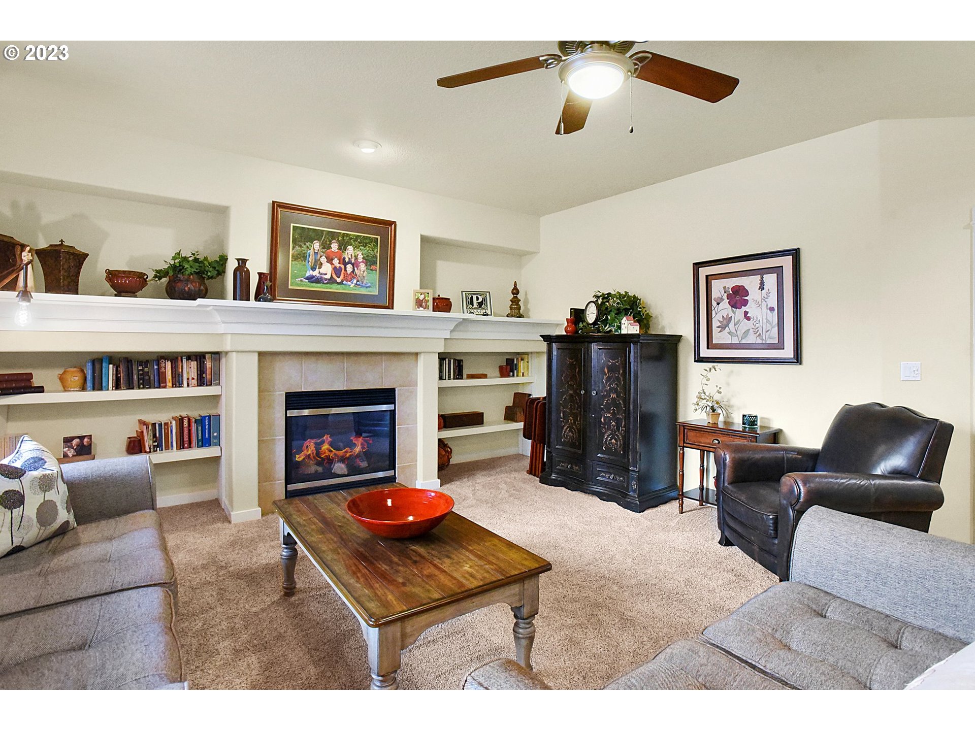 7826 Southwest Alder Street Tigard, OR 97224 - Photo 7 of 30 a living room with furniture and a fireplace