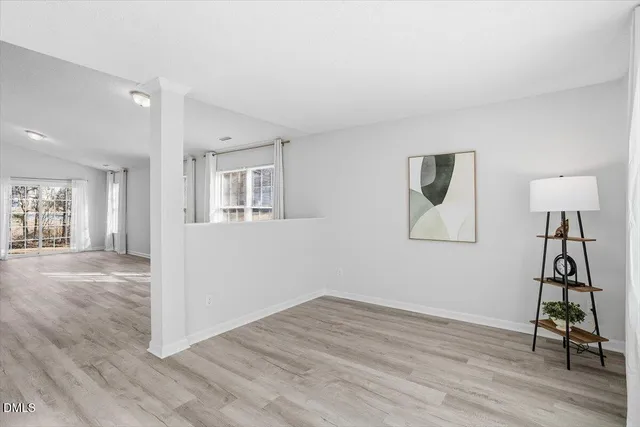 a view of a livingroom with wooden floor and a cabinet