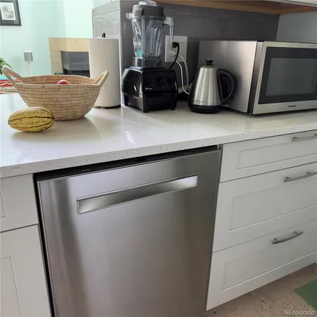 a kitchen with a refrigerator and cabinets