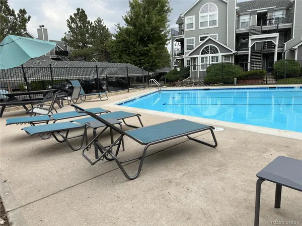 a view of a patio with a table and chairs