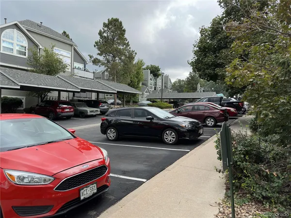 a couple of cars parked in front of a house