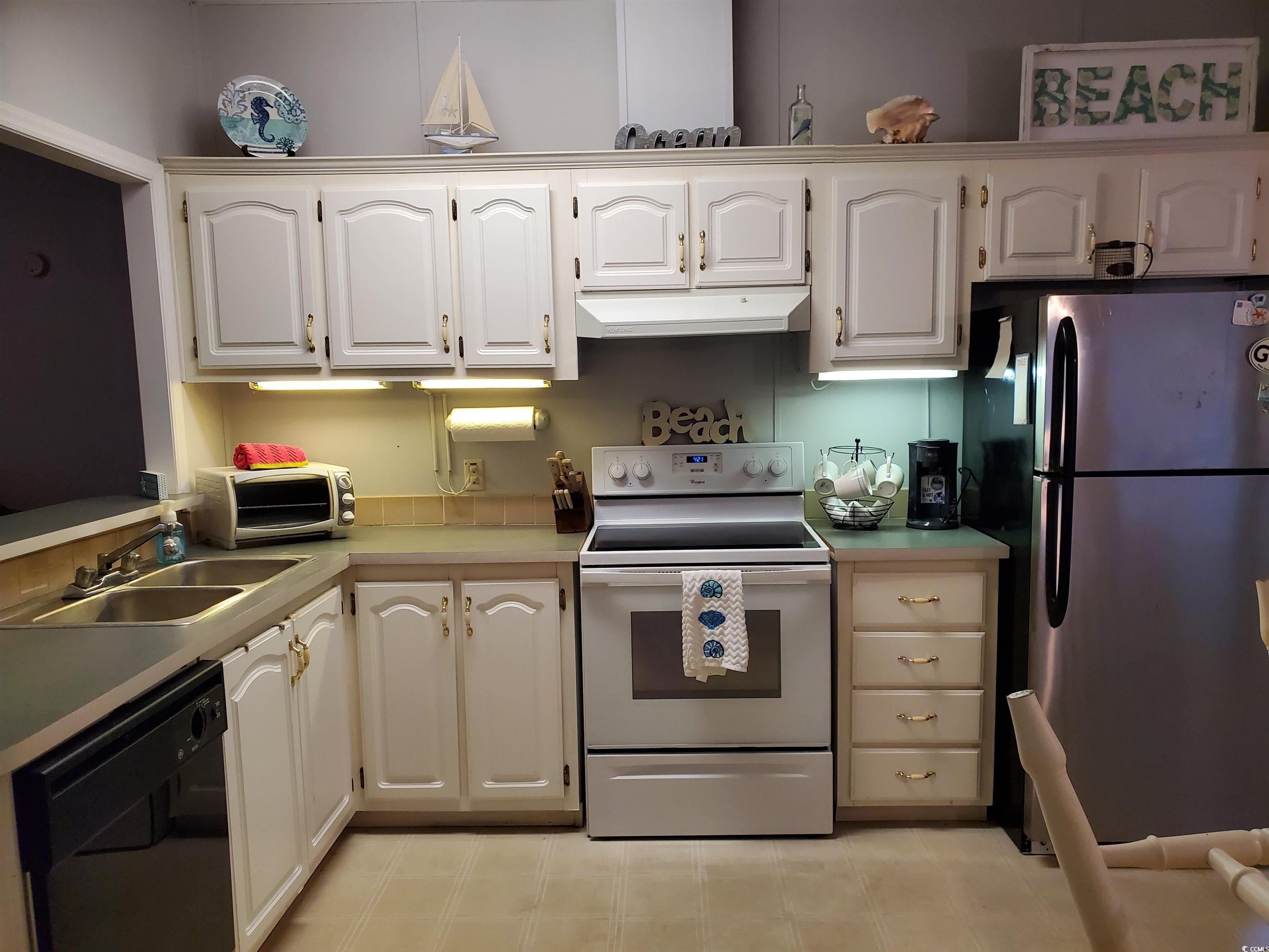 441 Delton Drive Murrells Inlet, SC 29576 - Photo 16 of 30 Kitchen featuring sink, stainless steel fridge, dishwasher, white cabinetry, and electric range