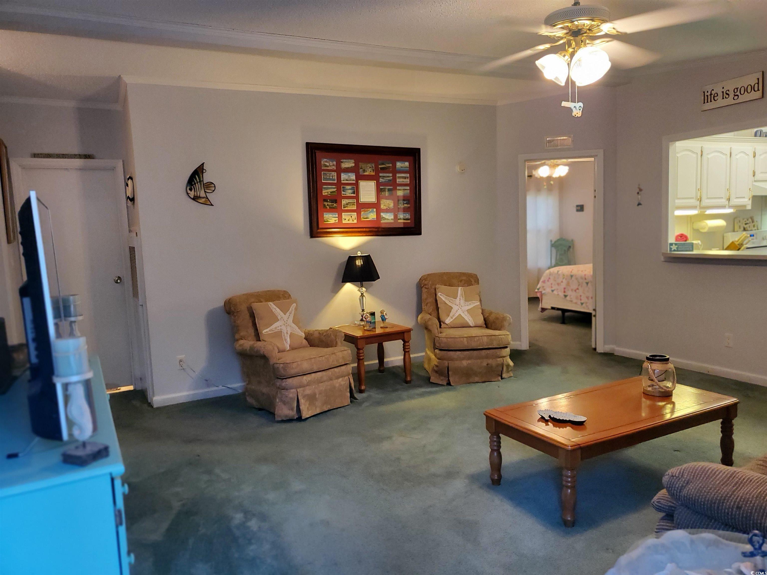 441 Delton Drive Murrells Inlet, SC 29576 - Photo 20 of 30 Carpeted living room with ceiling fan and ornamental molding