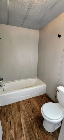 a bathroom with a toilet and a tub