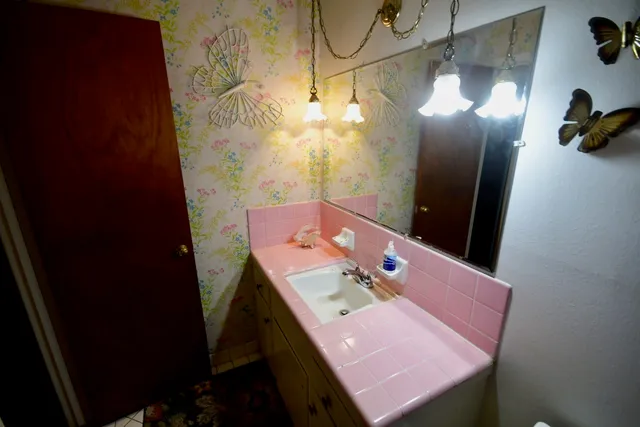 a bathroom with a sink and mirror