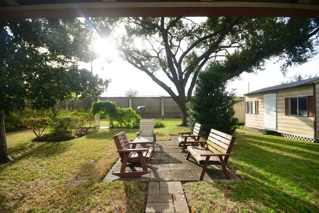 a view of a yard with furniture and garden