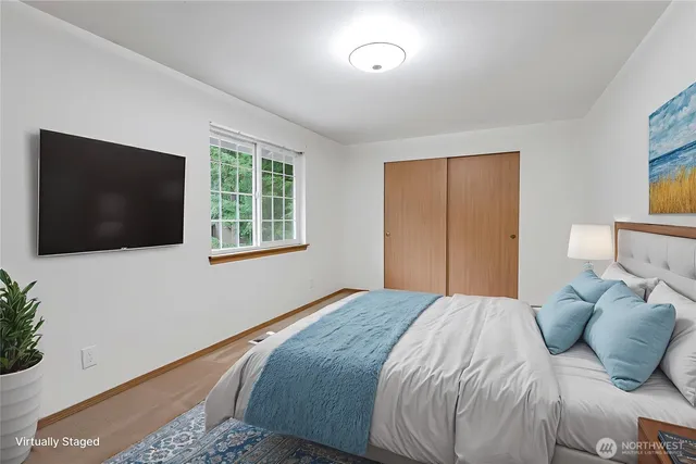 a bedroom with a large bed and a flat screen tv