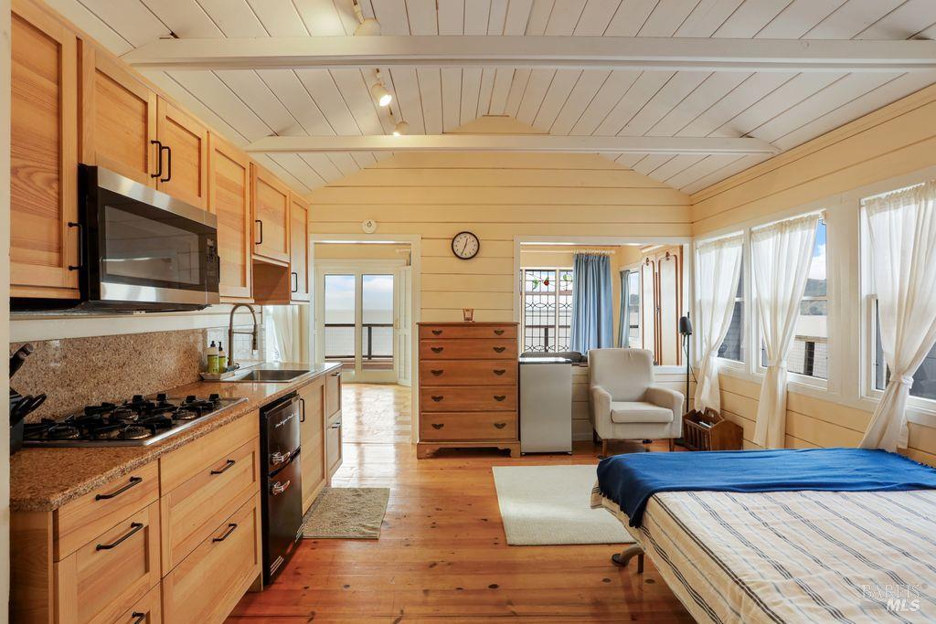 34 Sandy Beach Road Vallejo, CA 94590 - Photo 49 of 63 a spacious bedroom with bed and wooden floor