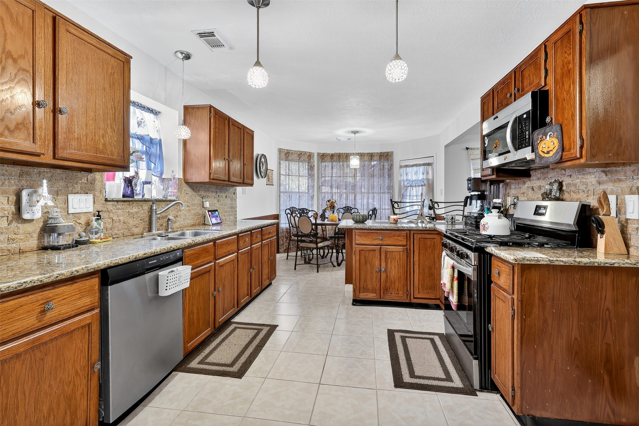 3402 Crystal Dove Drive Spring, TX 77388 - Photo 8 of 33 a kitchen with stainless steel appliances granite countertop a sink a stove top oven a counter space and cabinets