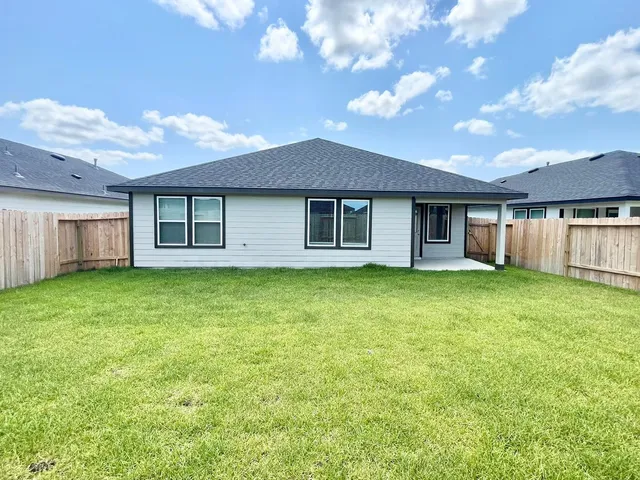 a view of a house with a backyard