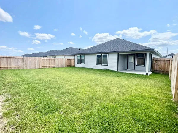 a view of a house with a yard and sitting area