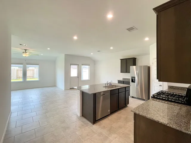 a kitchen with stainless steel appliances granite countertop a stove and a sink