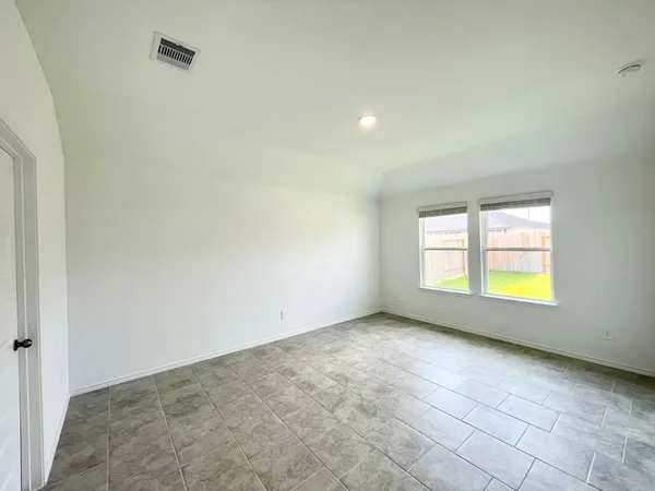 an empty room with a empty space and windows