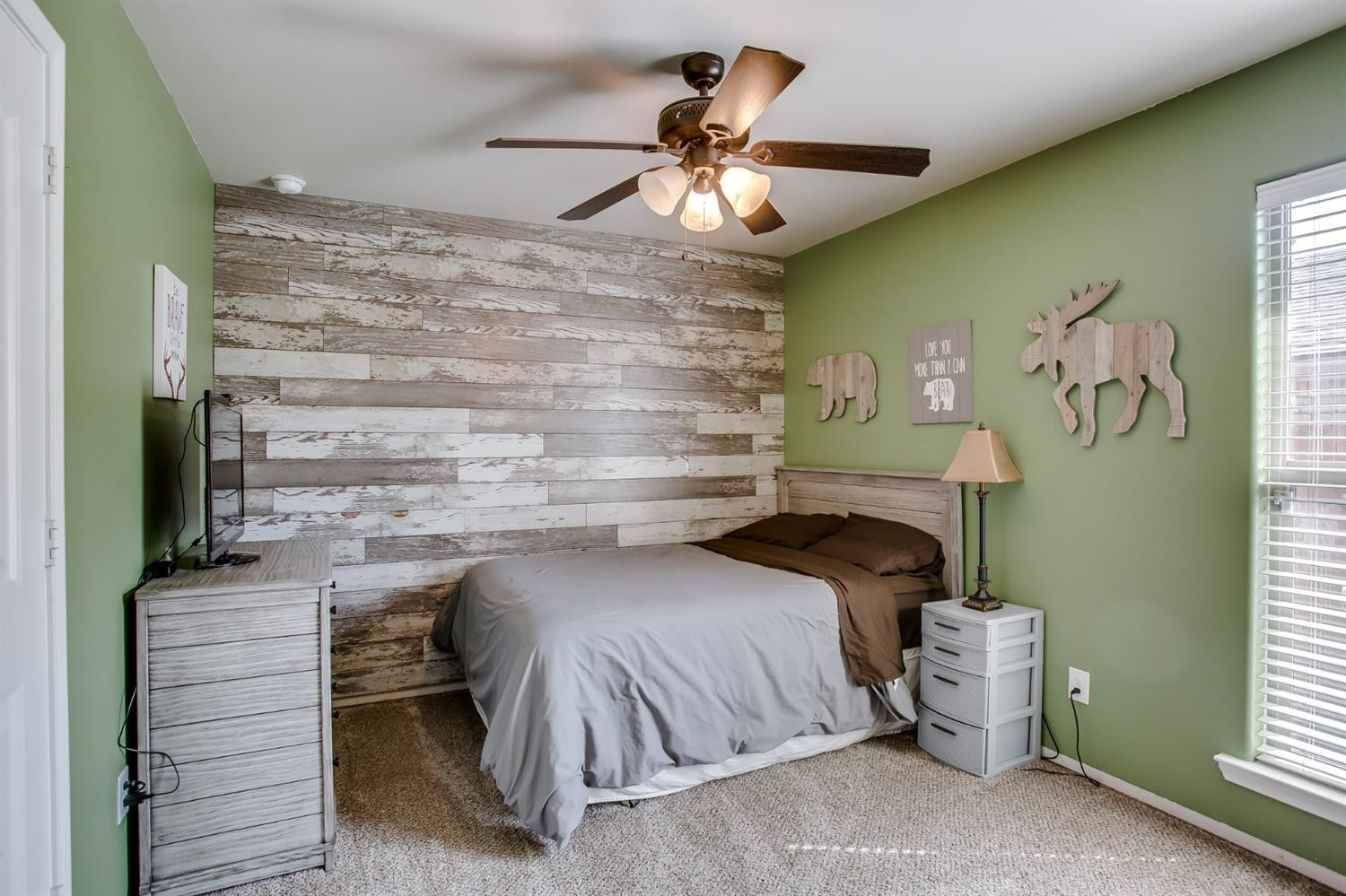 7449 104th Street Lubbock, TX 79424 - Photo 12 of 16 a bedroom with a bed and a chandelier