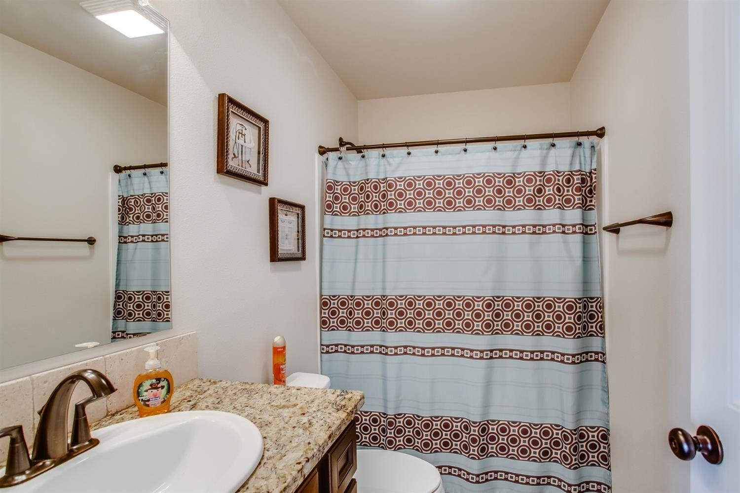 7449 104th Street Lubbock, TX 79424 - Photo 13 of 16 a bathroom with a sink toilet and shower