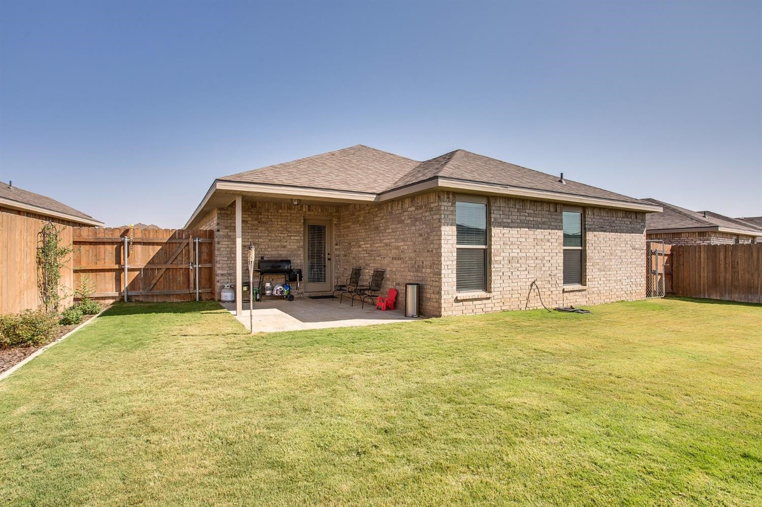 7449 104th Street Lubbock, TX 79424 - Photo 15 of 16 a view of a house with pool and a back yard