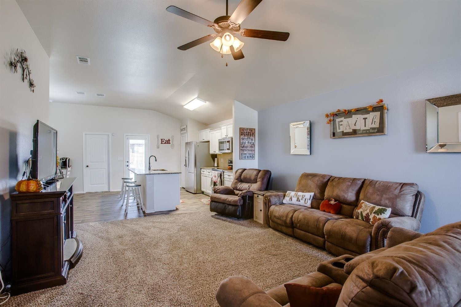 7449 104th Street Lubbock, TX 79424 - Photo 2 of 16 a living room with furniture and a chandelier
