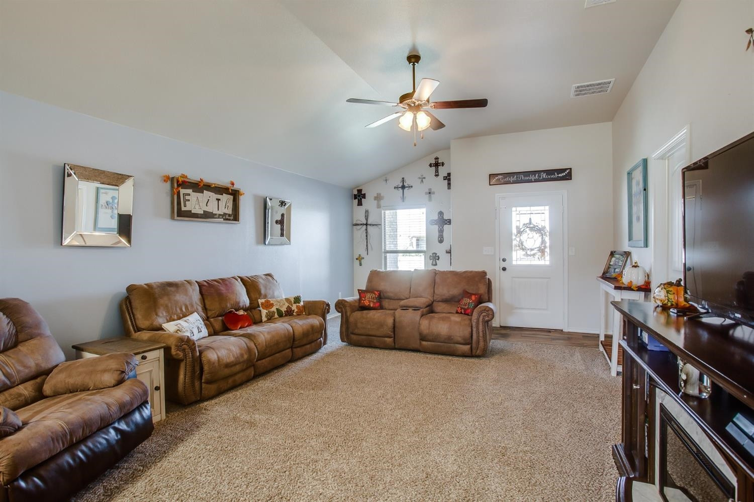 7449 104th Street Lubbock, TX 79424 - Photo 3 of 16 a living room with furniture and a flat screen tv