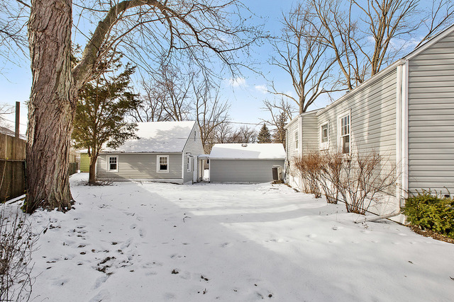 124 Village Road Willowbrook, IL 60527 - Photo 2 of 10 a white house that has a tree in front of it