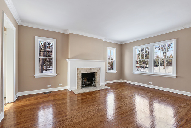 124 Village Road Willowbrook, IL 60527 - Photo 3 of 10 a view of an empty room with window and wooden floor