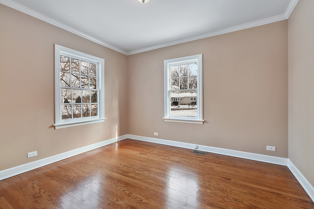 124 Village Road Willowbrook, IL 60527 - Photo 5 of 10 a view of a big room with wooden floor and windows