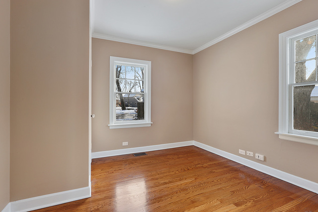 124 Village Road Willowbrook, IL 60527 - Photo 6 of 10 a view of an empty room with wooden floor and a window