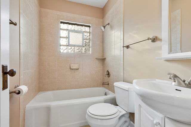 124 Village Road Willowbrook, IL 60527 - Photo 7 of 10 a bathroom with a sink a toilet and shower