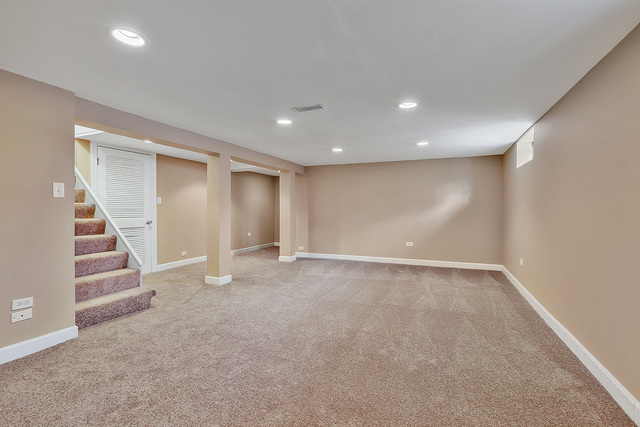 124 Village Road Willowbrook, IL 60527 - Photo 9 of 10 an empty room with a staircase