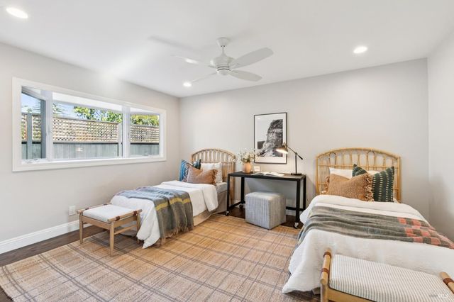 a bedroom with two beds and a window