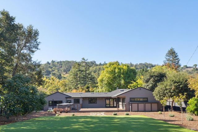 a big house with a big yard and large trees