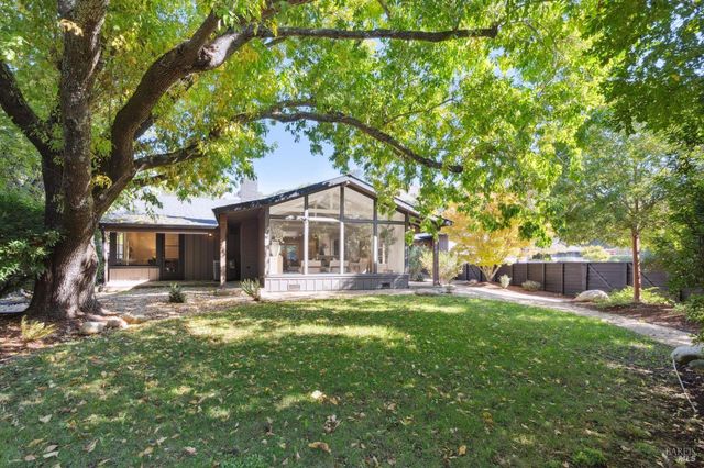 a house view with a sitting space and garden