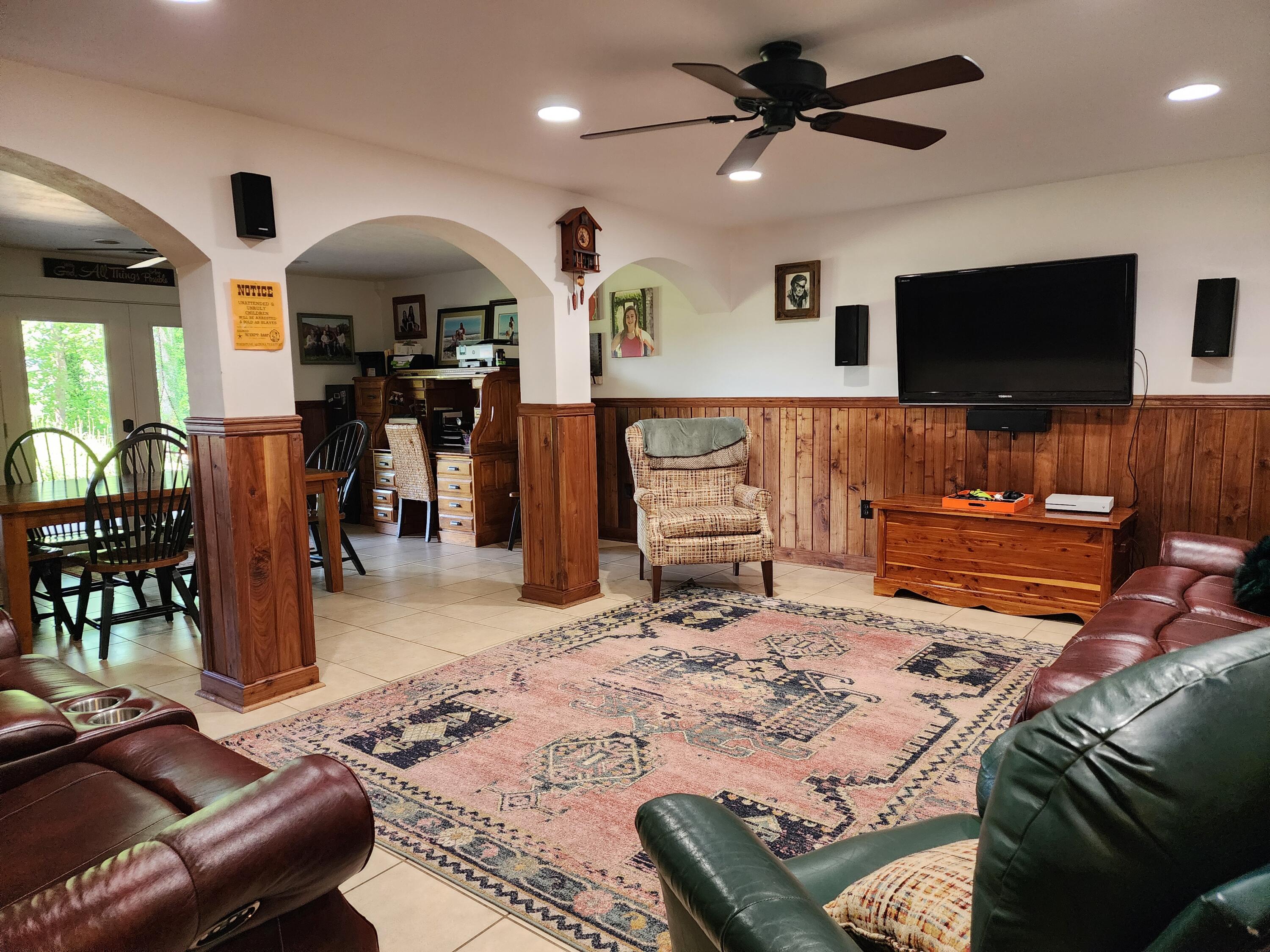 1199 Muse Field Road Rocky Mount, VA 24151 - Photo 32 of 41 a living room with furniture a flat screen tv and kitchen view