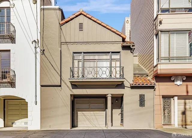 a view of a brick house with large windows