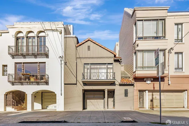 a view of a brick house with large windows