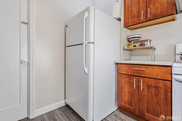 a kitchen with metallic refrigerator freezer and a dishwasher