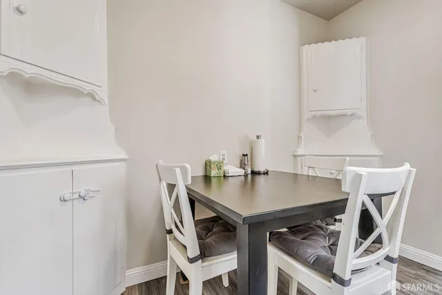 a view of a workspace with furniture and wooden floor
