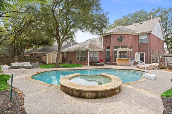 a view of a house with swimming pool and sitting area