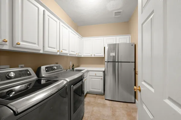 a kitchen with a refrigerator stove and cabinets