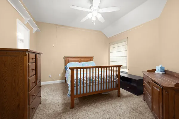 a bed room with a bed and a chandelier