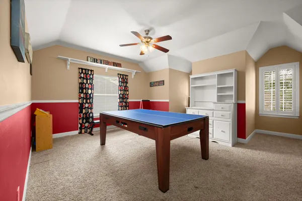 a room with furniture pool table and windows