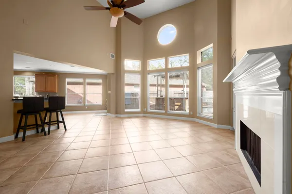 a view of an empty room with a fireplace and a window