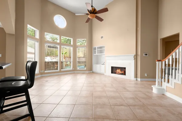 a view of an empty room with a fireplace and a window
