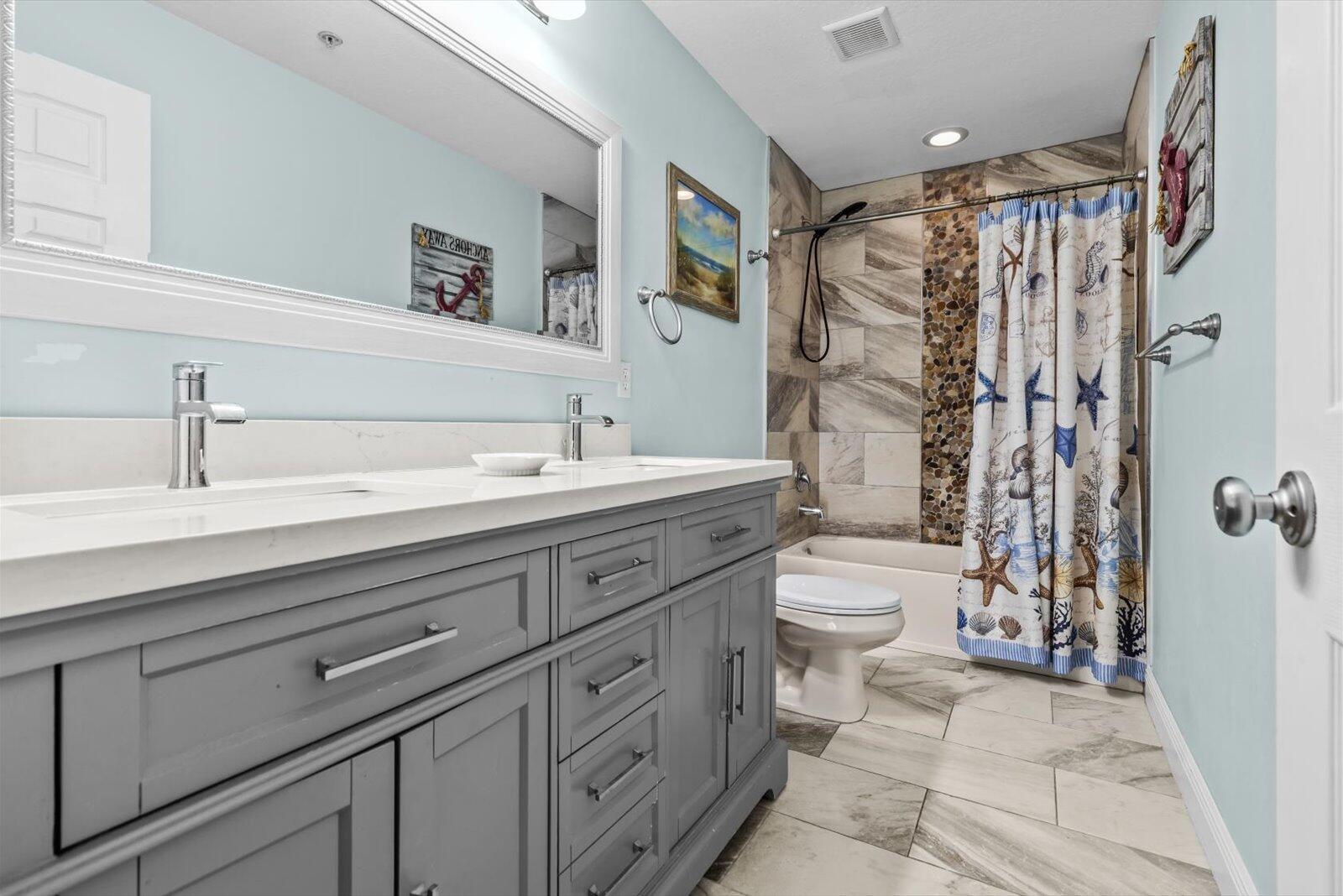 5290 Southeast Mitchell Lane Stuart, FL 34997 - Photo 19 of 43 a bathroom with a double vanity sink toilet and shower