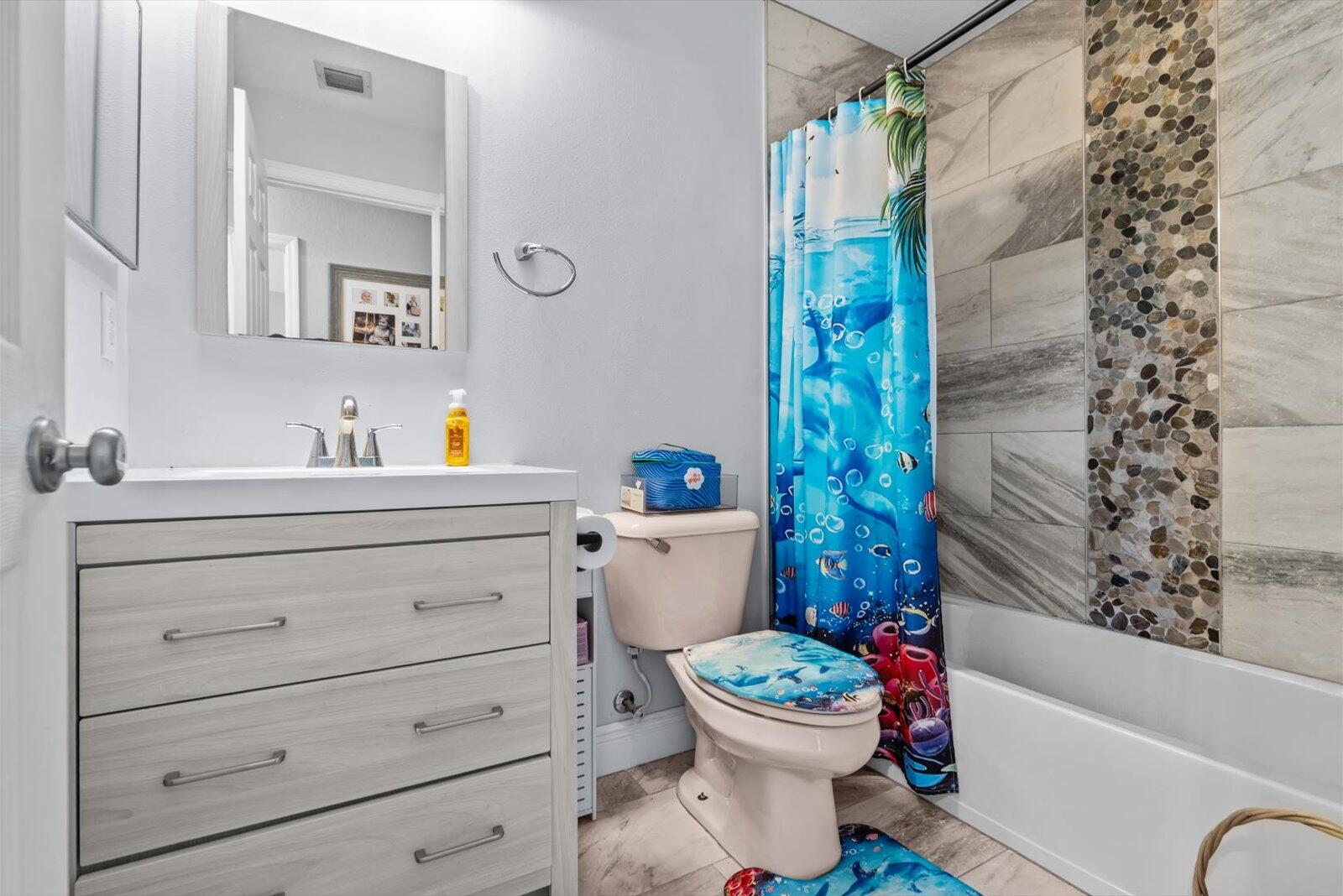 5290 Southeast Mitchell Lane Stuart, FL 34997 - Photo 22 of 43 a bathroom with a sink toilet and shower