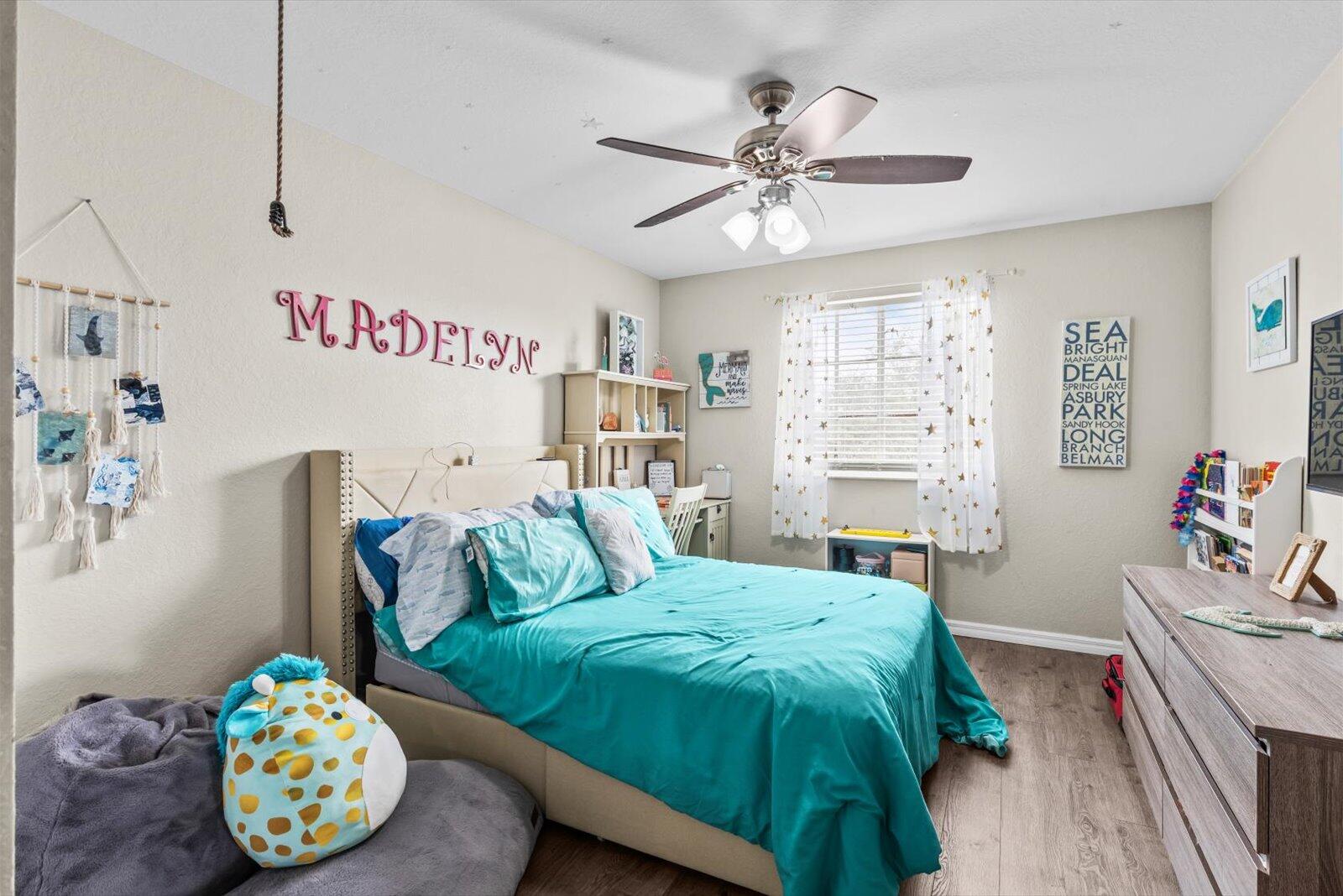 5290 Southeast Mitchell Lane Stuart, FL 34997 - Photo 25 of 43 a bedroom with a bed and a chandelier
