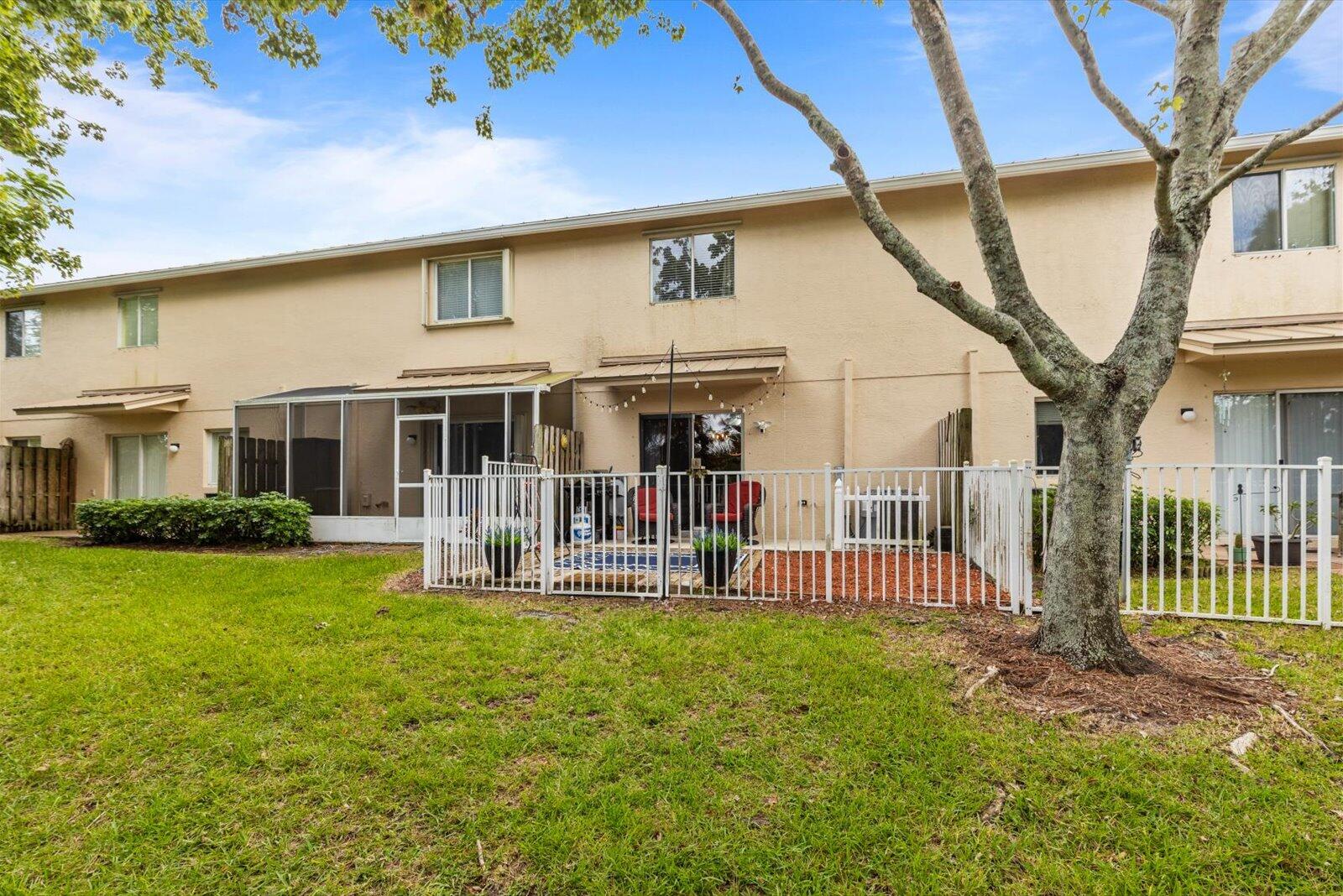 5290 Southeast Mitchell Lane Stuart, FL 34997 - Photo 29 of 43 a front view of a house with a garden and porch