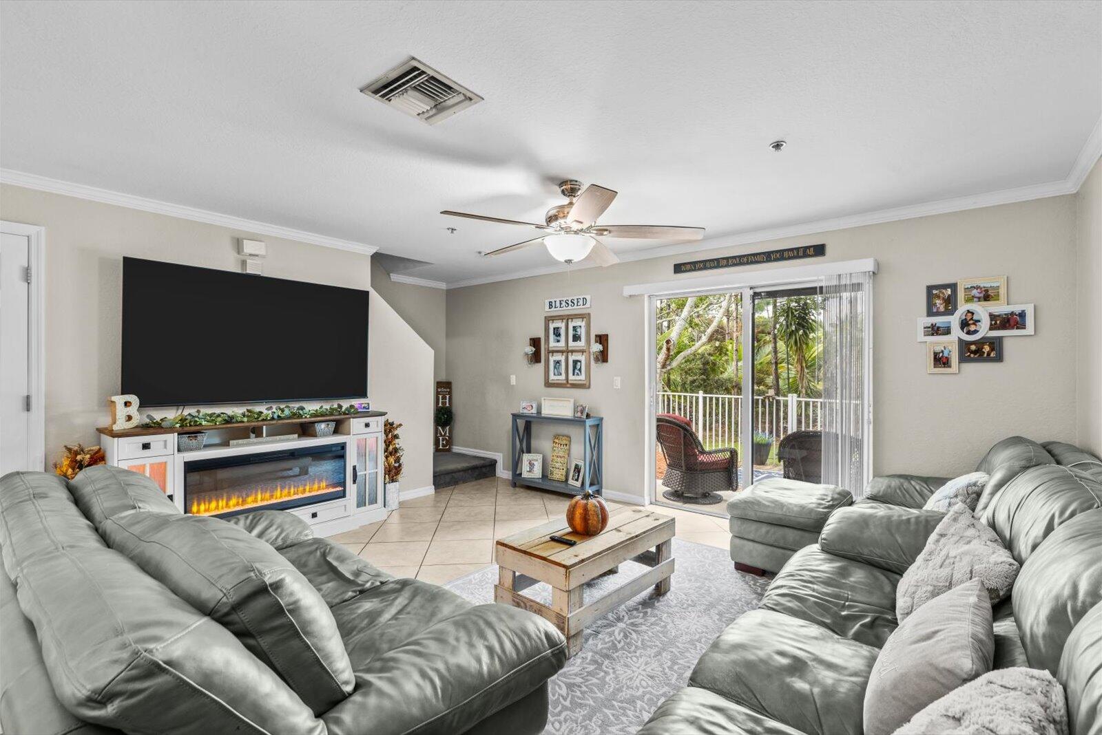 5290 Southeast Mitchell Lane Stuart, FL 34997 - Photo 5 of 43 a living room with furniture and a flat screen tv
