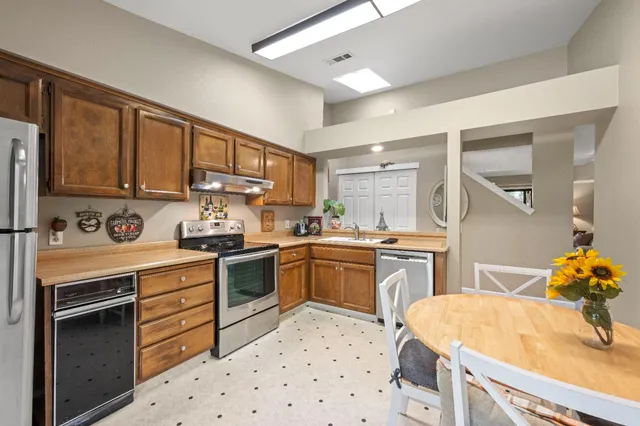 a kitchen with a sink stove and wooden cabinets